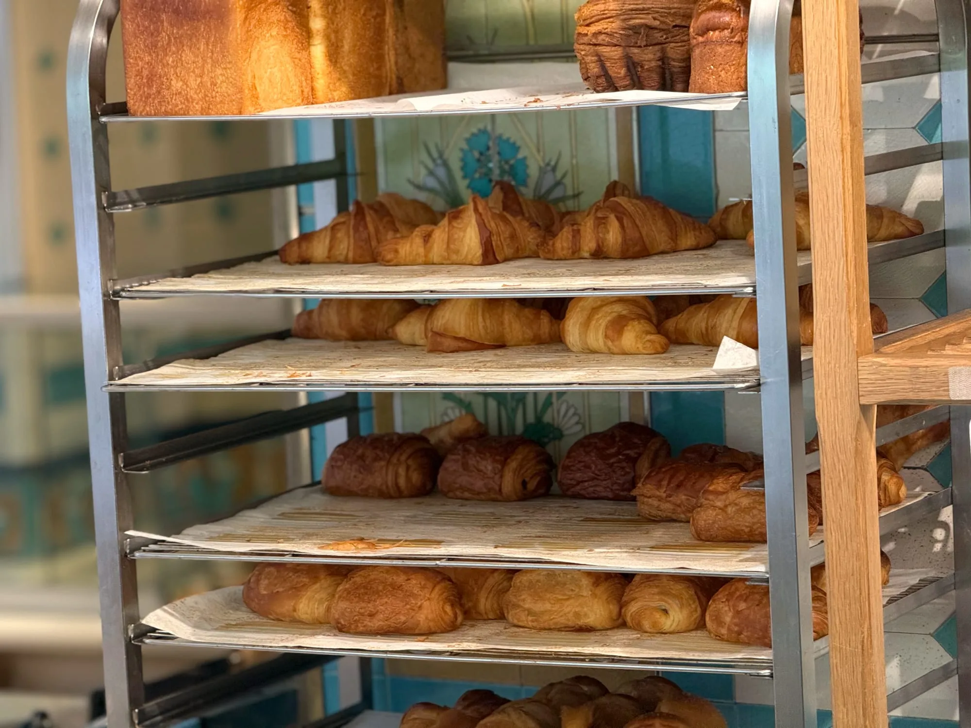 A rack of fresh croissants in a Paris bakery