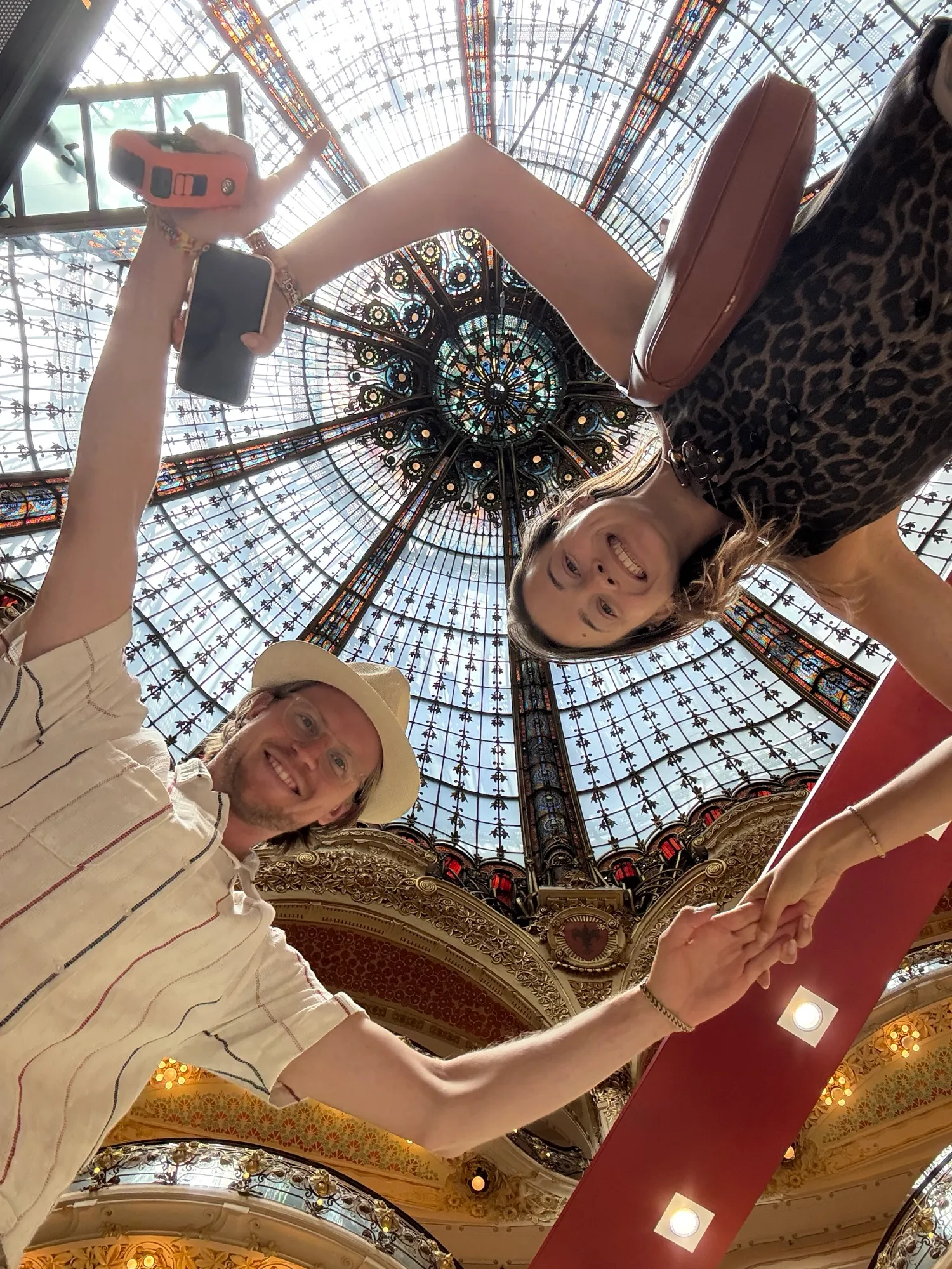 Guests laughing under the stained glass dome of Galeries Lafayette