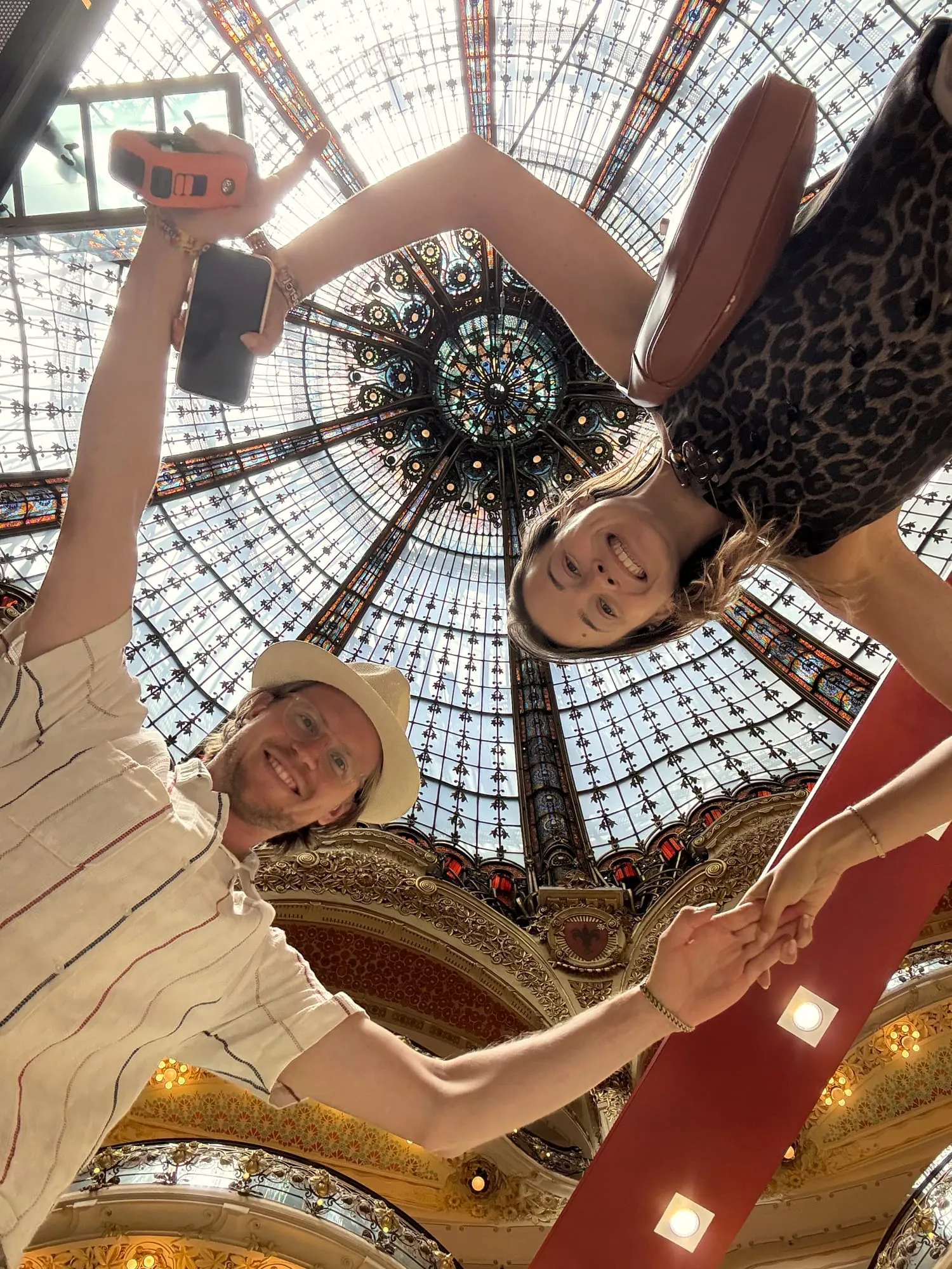 Guests laughing under the stained glass dome of Galeries Lafayette