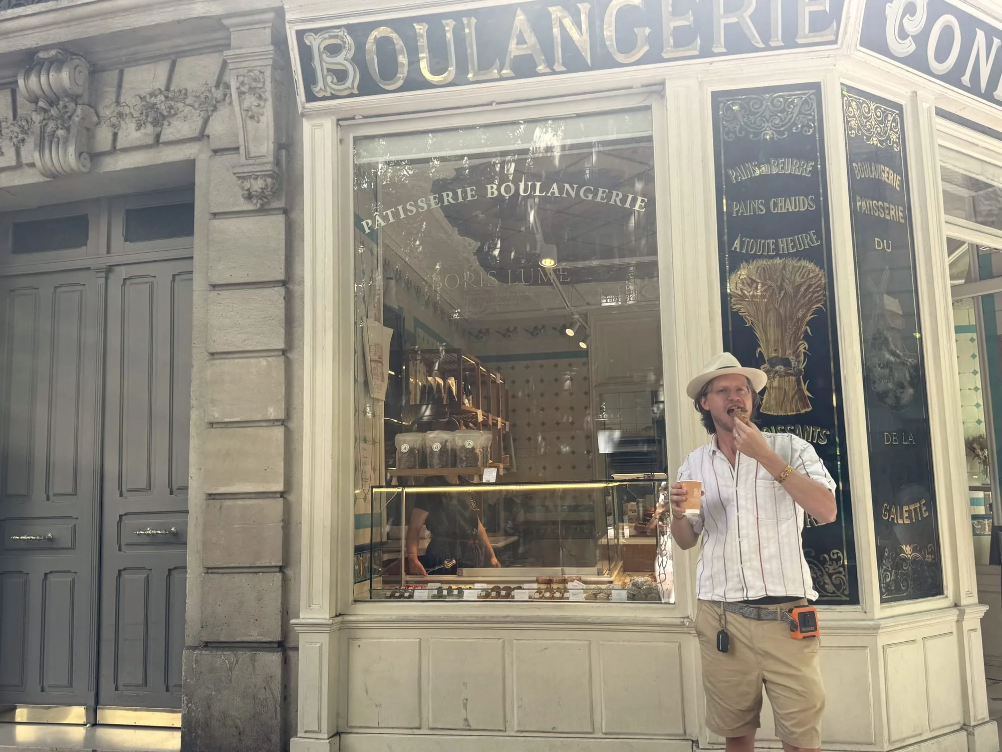 Corner boulangerie storefront with gold lettering in Paris