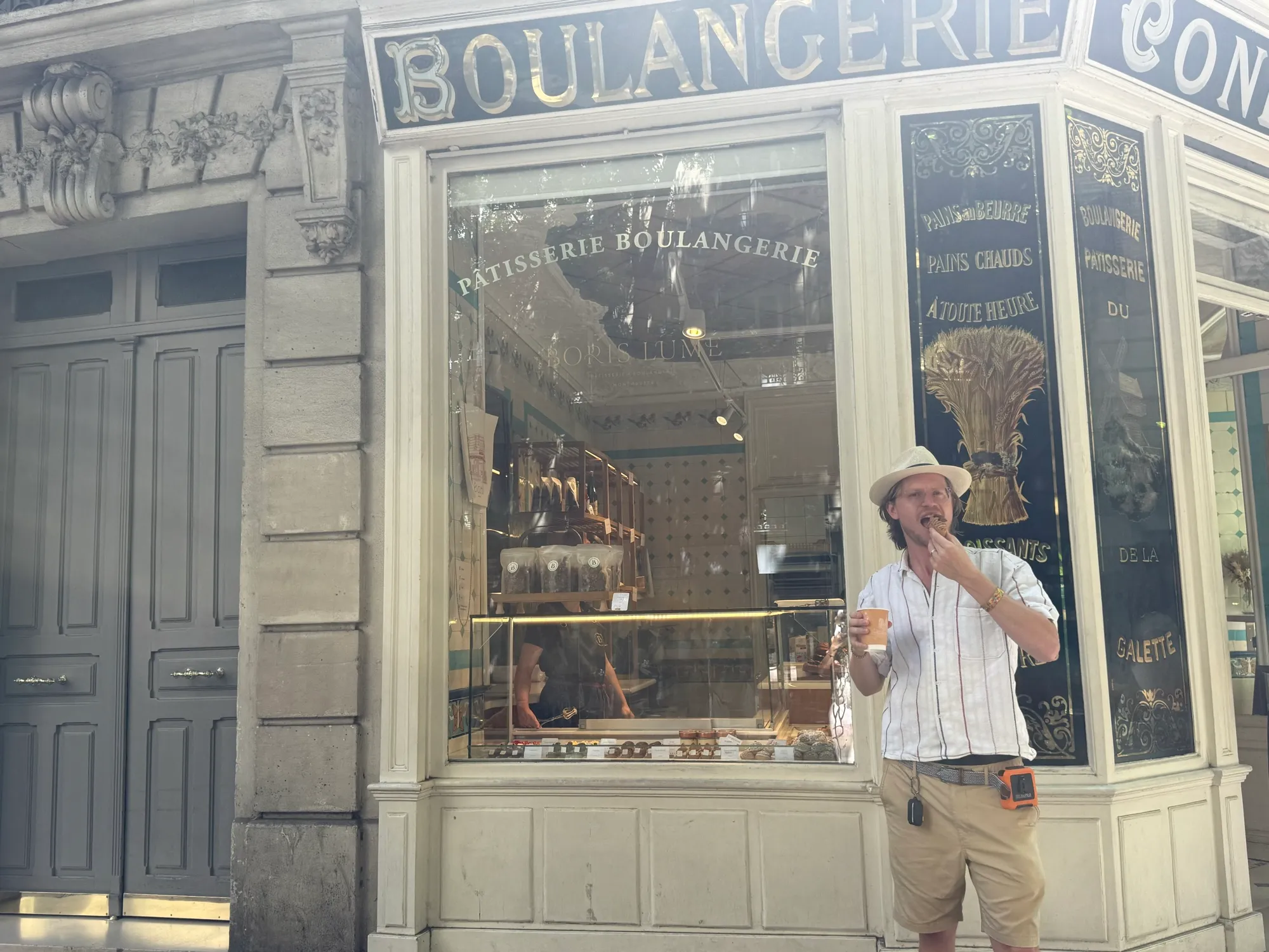 Corner boulangerie storefront with gold lettering in Paris