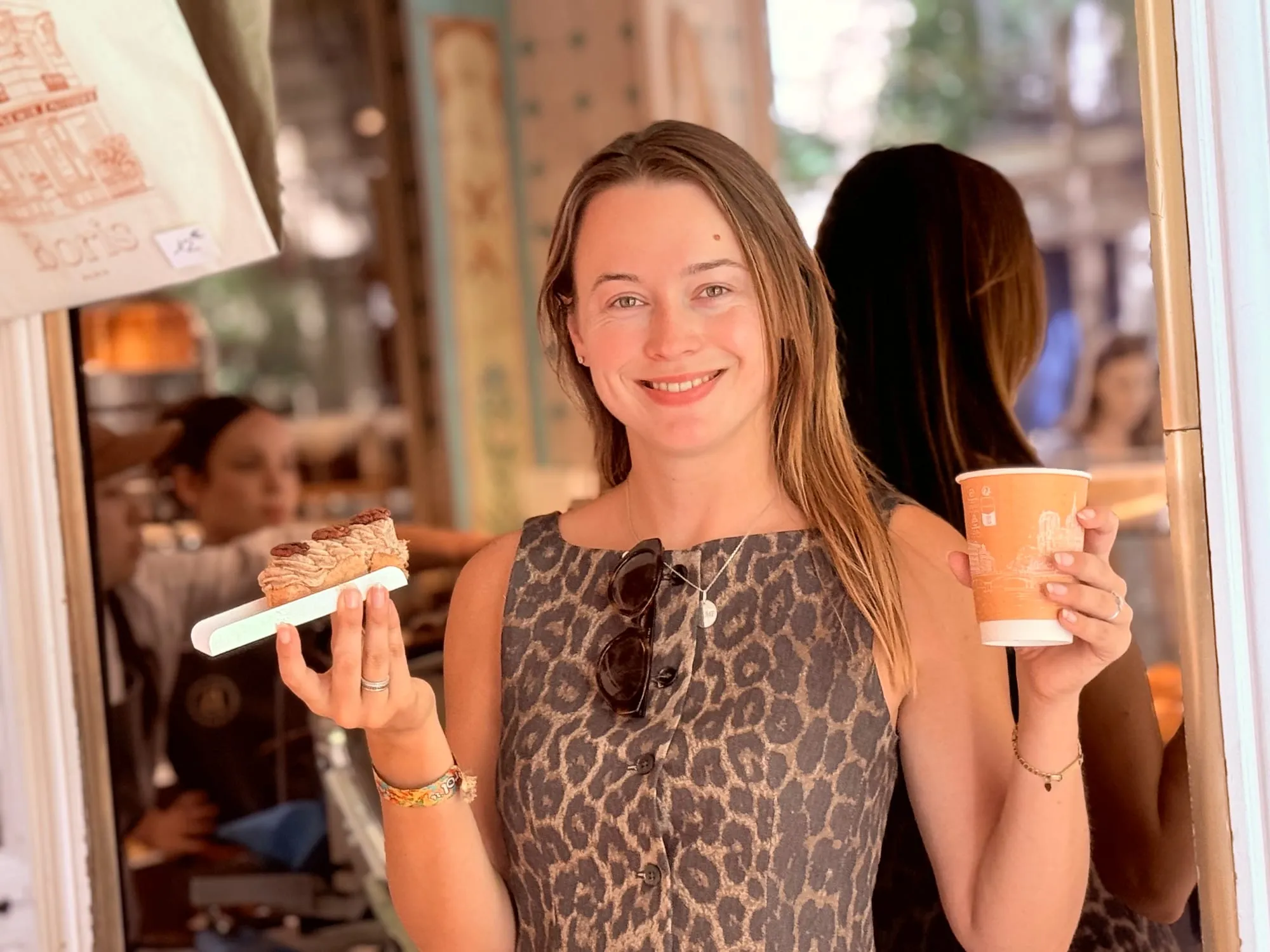 Guests smiling over pastries and coffee at a small table