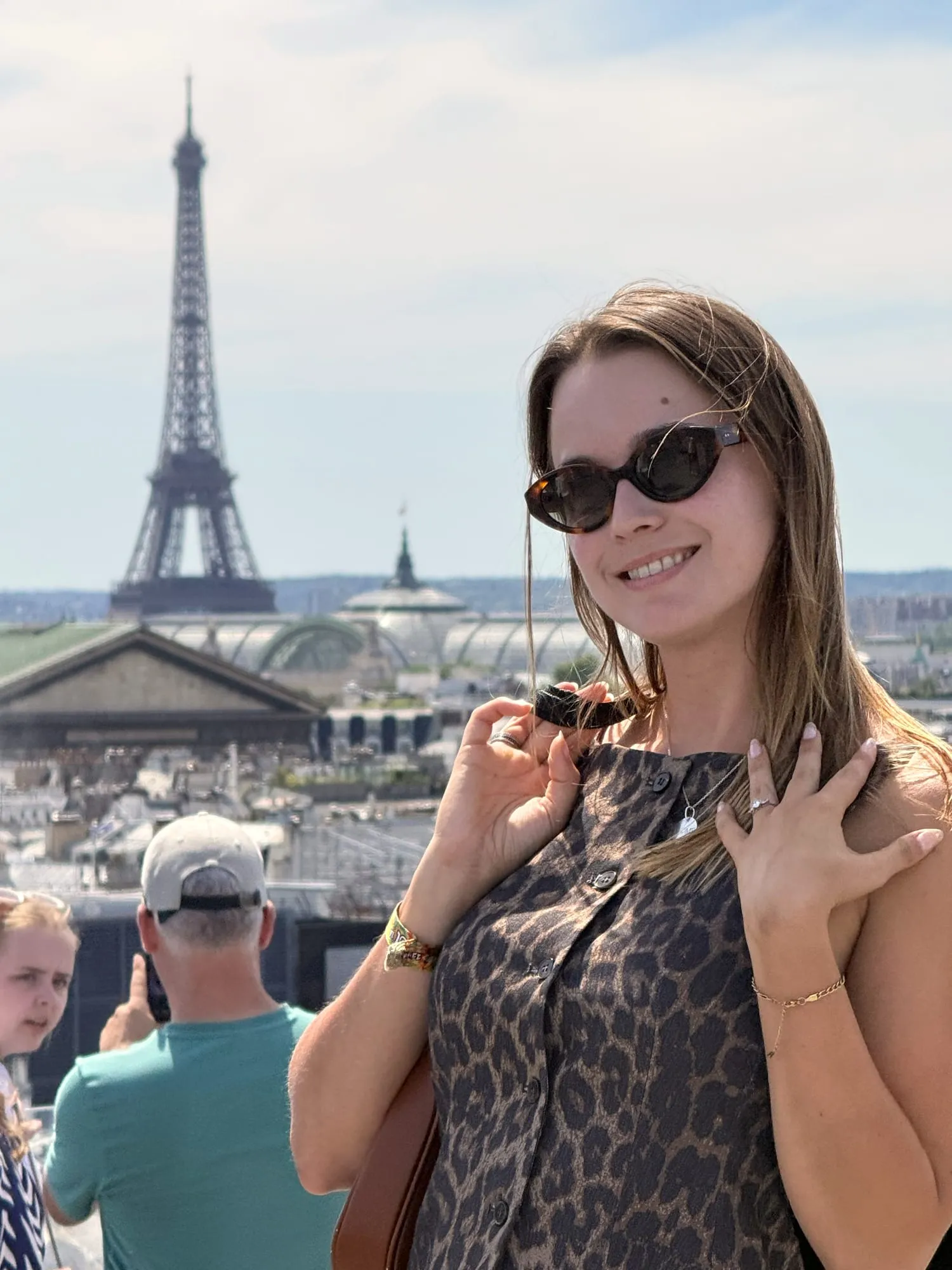 Two guests on a rooftop terrace with the Eiffel Tower behind them