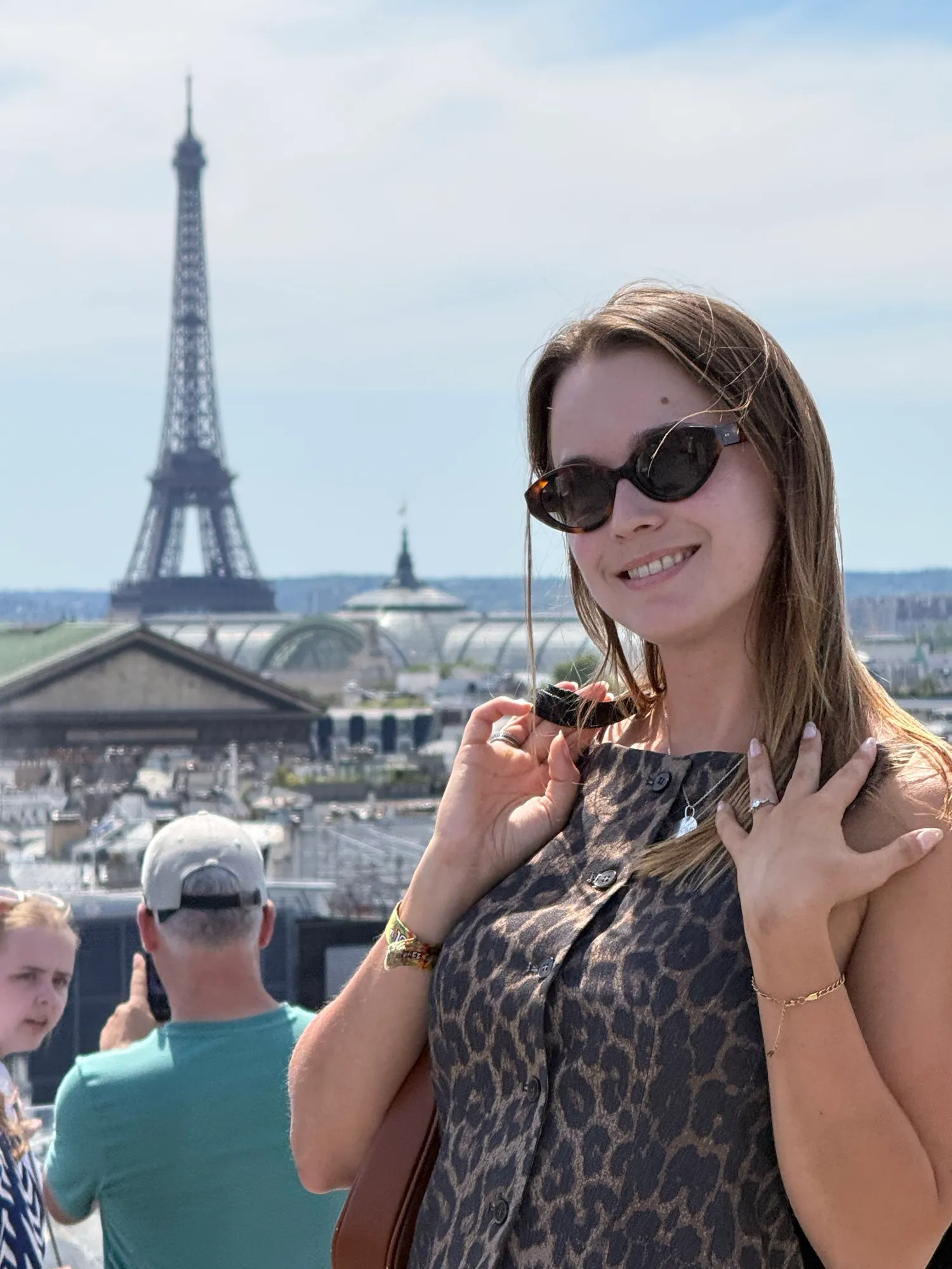 Two guests on a rooftop terrace with the Eiffel Tower behind them