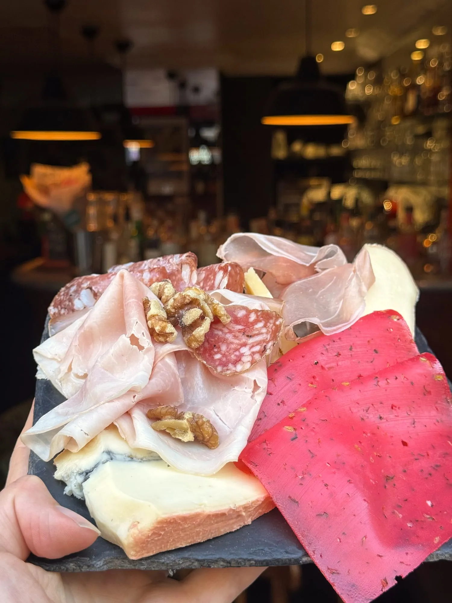 Charcuterie and cheese board on a wine bar counter