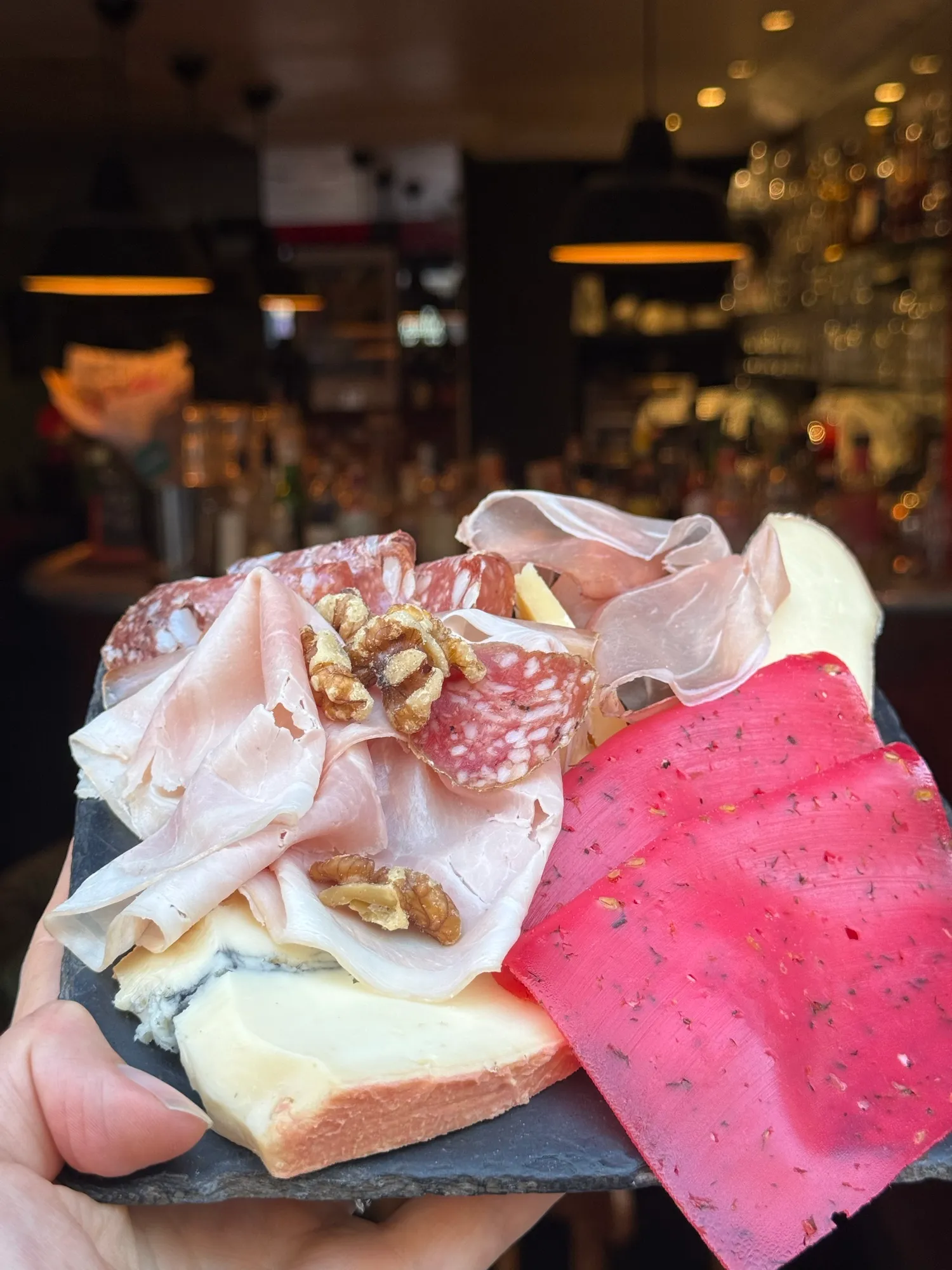 Charcuterie and cheese board on a wine bar counter